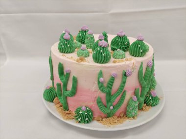 Cake decorated with cactus on a white background in a restaurant, cactus theam cake