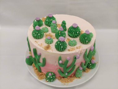 Cake decorated with cactus on a white background in a restaurant, cactus theam cake