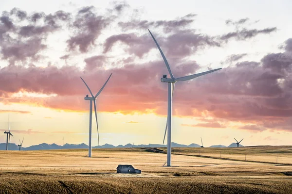 Sunset Windmills Producing Green Energy Overlooking Harvested Agriculture Fields Distant Stock Photo