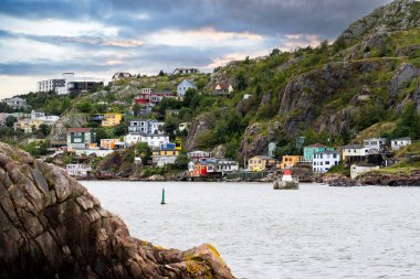 Old Battery colourful East coast homes photograph taken from Fort Amherst historic site along the East Coast Hiking Trail overlooking the Narrows at St. John's Newfoundland Canada. clipart