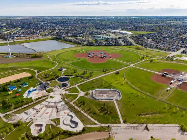 stock image Airdrie Alberta Canada, May 21 2024: High aerial Chinook Winds Park overlooking baseball diamonds and distant storm water retention pond