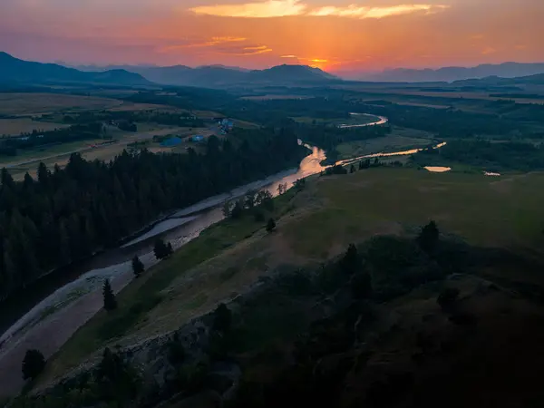 stock image Forest fire smoke creates moody reflection on Castle River overlooking the Crowsnest Pass and Canadian Rockies in Southern Alberta.