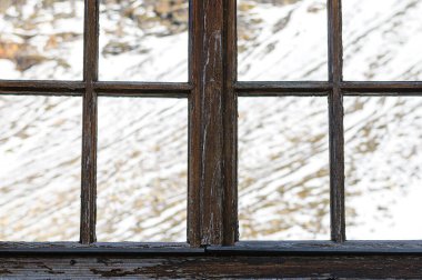 Reflection of snow covered mountain in windows clipart