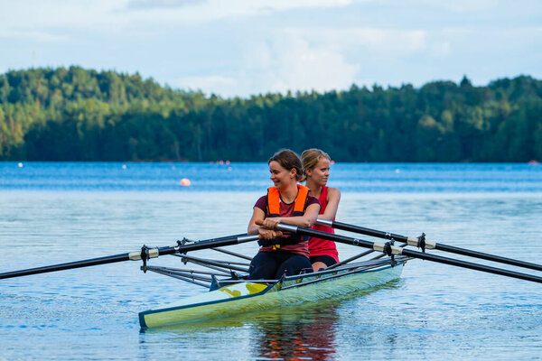 Pair of Womans rowing on lake