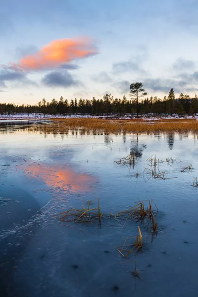 Sunset at still frozen lake, Sweden