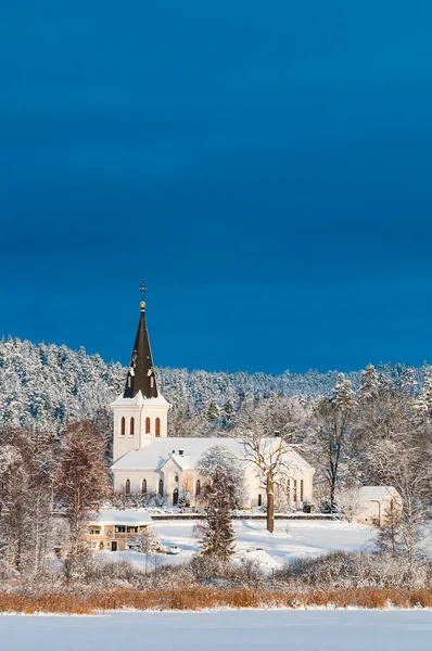 The church in Hannas, Sweden is a majestic place of worship surrounded by wintery snow and trees coated with frost.
