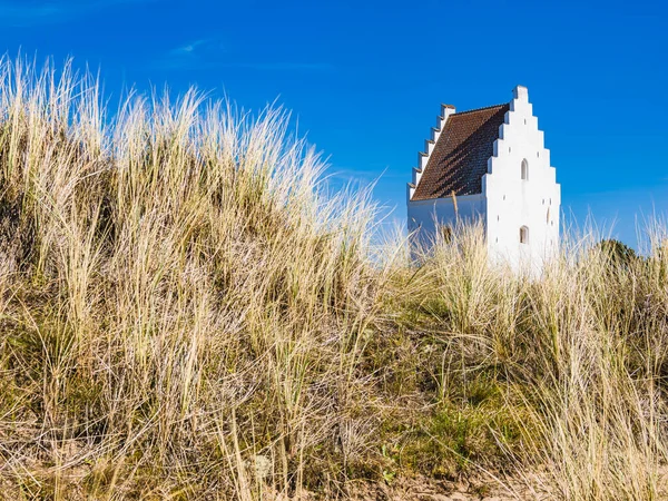 stock image Old church in Skagen among land and prairies with blue sky.