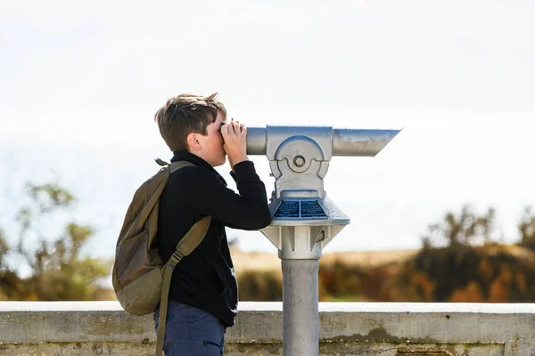 stock image kid looking at sightseeing binoculars in european city