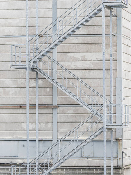 Industrial staircase in exterior building facade with fabric detail.