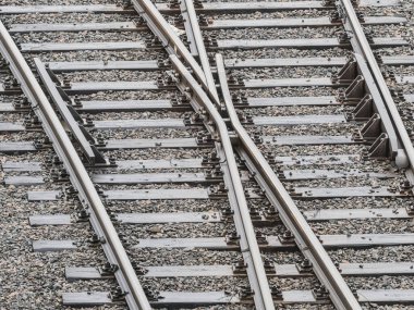 Göteborg 'daki demiryolu raylarının kesiştiği görülüyor. Bu da kentin ulaşım sisteminin karmaşık planını gösteriyor. Metalden yansıyan güneş ışığı rayların detaylarını vurguluyor..