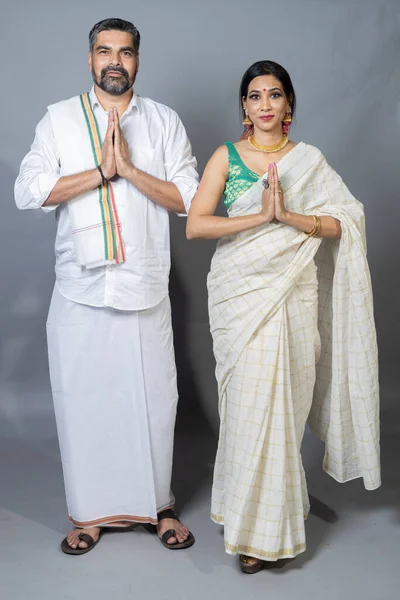 south indian couple standing with Join hands welcome position