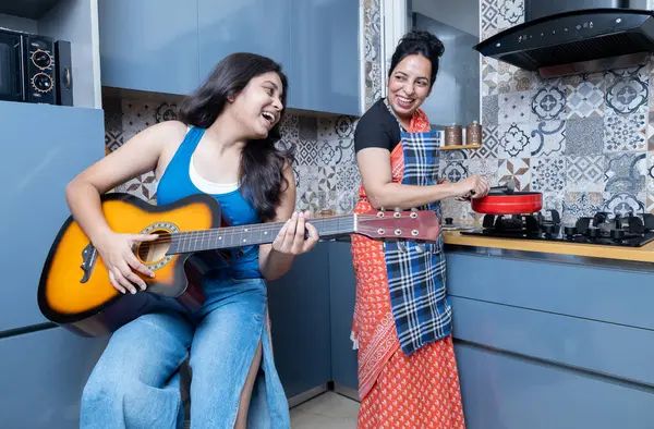 stock image Indian mother and daughter in kitchen having cooking fun. Daughter and Mother having fun together in kitchen