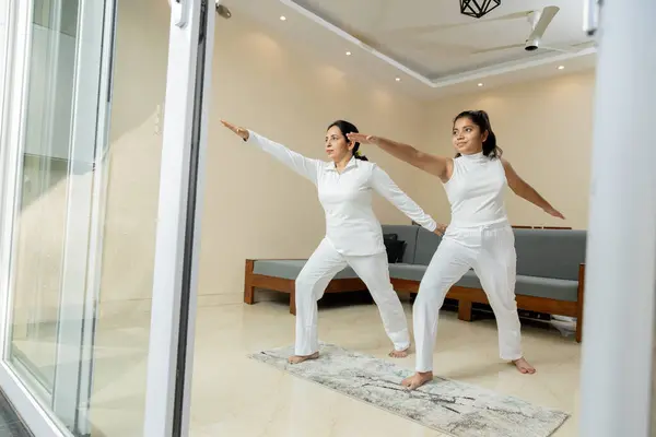 stock image Indian woman Mother and Daughter doing exercise at home ,Mother and Daughter doing yoga poses at home