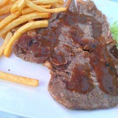 Biber soslu ızgara biftek ve patates kızartması.