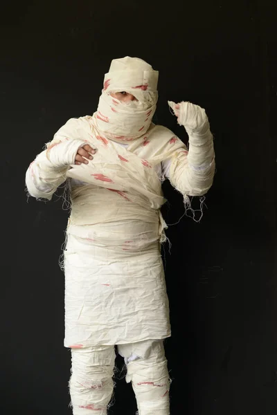 Stock image Bandaged mummy in standing position with black background on Halloween day.