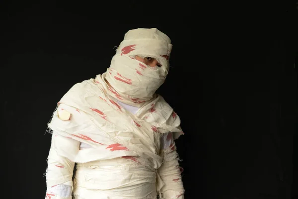 stock image Bandaged mummy in standing position with black background on Halloween day.