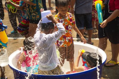 AYUTTHAYA, THAILAND, APRIL 13, 2018: Unidentified Thai peoples playing and enjoy water spray with plastic bowl and guns. Participate in Songkran Festival This is a traditional New Year celebration in Ayutthaya Province. Middle of Thailand.