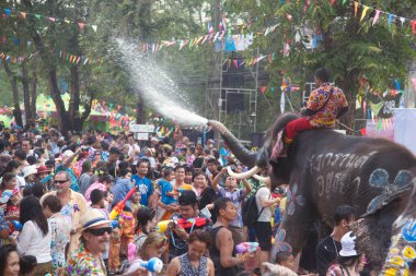 Ayutthaya, Thailand - April 13,2018: Thai people and traveler foreigner join with Songkran Festival is celebrated in a traditional New Year's Day from April 13 to 15, with the splashing water with elephants at a road in Ayutthaya Province ,Thailand. 