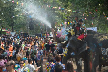 Ayutthaya, Thailand - April 13,2018: Thai people and traveler foreigner join with Songkran Festival is celebrated in a traditional New Year's Day from April 13 to 15, with the splashing water with elephants at a road in Ayutthaya Province ,Thailand. 