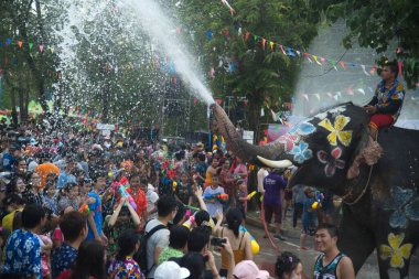 Ayutthaya, Thailand - April 13,2018: Thai people and traveler foreigner join with Songkran Festival is celebrated in a traditional New Year's Day from April 13 to 15, with the splashing water with elephants at a road in Ayutthaya Province ,Thailand. 