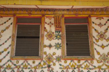 Traditional Thai art pattern made of wood decorated at the window of Thai Church at Wat Somdet, a historic site in Amphoe Sangkhlaburi, Kanchanaburi Province , Middle of Thailand. 