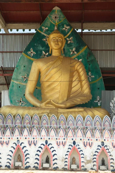 A large indoor golden sitting Buddha image at Wat Somdet in Amphoe Sangkhlaburi. A historic site in Kanchanaburi Province ,Middle of Thailand. A combination of Thai-Raman and Myanmar art.