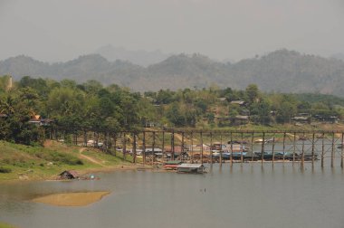 Mon Bridge or Uttamanusorn Bridge is a wooden bridge used to cross the Songkhlalia river to Mon village. It is a wooden bridge that is 445 meters long. Location Sangkhlaburi, Kanchanaburi , Thailand.
