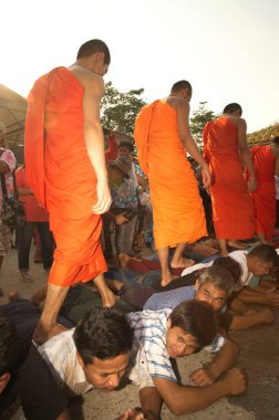 KANCHANABURI, THAILAND - 16 APR 2016: Tanımlanamayan bir erkek köylü Thera 'nın sırt üstü yürümesi için birleşip yan yana yatacaktı. Wat Wangwiwegaram, Sangkhlaburi Bölgesi, Kanchanaburi Songkran Festivali, Tayland. 