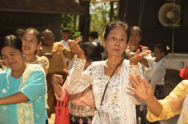 KANCHANABURI, THAILAND - 16 Nisan 2016: Songkran 'daki Kanchanaburi Eyaleti Wat Wang Wiwekaram, Sunkhaburi Festivali' nde düzenlenen törende kimliği belirsiz kadın azınlık dansı, Chat Gold 'u kum ve renkli bayraklarla taşıdı..