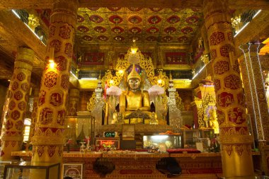 A large golden seated Buddha image is the main Buddha image in the Mahamuni Phrya Temple Church. It is located on the Rakhine State, Myanmar. clipart