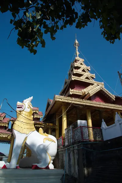 stock image A white lion statue adorns the front of the chapel or Buddhist church at Wat Mahamuni Phraya temple. It is located on the Rakhine State, Myanmar.