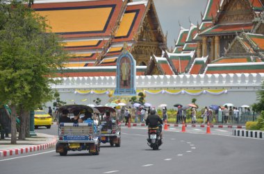 Bangkok, Tayland - 24 Ağustos 2024: Kimliği belirsiz bir adam 3 tekerlekli bir otomobil (tuk tuk) kullanıyor. Wat Phra Kaew civarındaki yolcuları al ve bırak. Burası önemli bir yer. Bu tür bir araç burada yaygın bir ulaşım aracı..