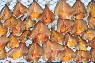 Texture and background of dried Gianf fish on a net tray. clipart