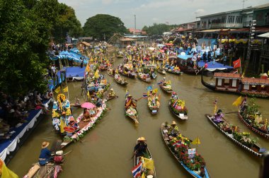 AYUTTHAYA ,THAILAND - AUG 1 , 2023 : Khao Phansa Candle Floating Festival, Wat Lad Chado, Ayutthaya. Another unique candle festival to mark the beginning of Khao Phansa period, Lad Chado Candle Procession in Ayutthayas made on water instead of land. clipart