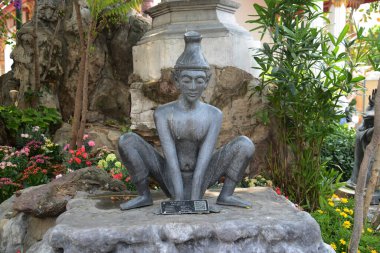 Statue of a hermit performing a massage therapy pose at Wat Phra Chetuphon Wimon Mangkhalaram or Wat Pho. This place is most famous forThai traditional massage. Located at Bangkok capital city in Thailand. clipart