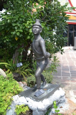 Statue of a hermit performing a massage therapy pose at Wat Phra Chetuphon Wimon Mangkhalaram or Wat Pho. This place is most famous forThai traditional massage. Located at Bangkok capital city in Thailand. clipart