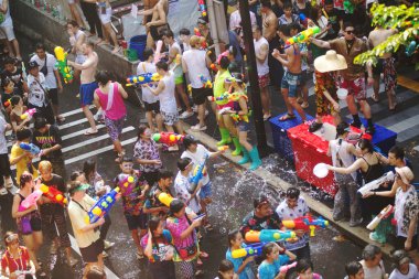 BANGKOK, THAILAND - 14 Nisan 2024: Tayland ve yabancı turistler Songkran Günü 'nde (Tayland Yeni Yıl / Su Festivali) sokaklara dans ederek, ateş ederek ve Silom yoluna su dökerek su sıçratıyorlar.