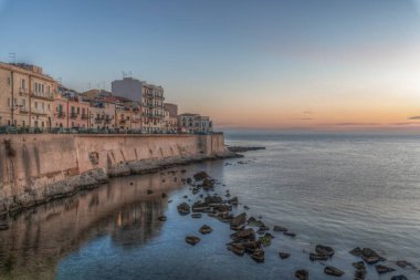 Syracuse Sicily. The dawn of a new day on the beautiful seafront of Ortigia