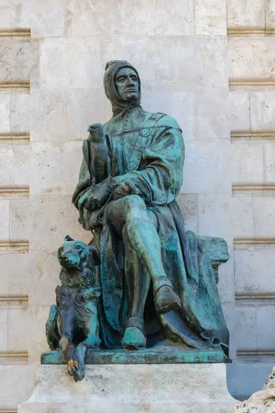 Bu heykel, yanında bir köpek ve pelerinle süslenmiş oturan tarihi bir figürü tasvir ediyor. Sanat eserleri, Matthias Fountain, Royal Castle, Budapeşte, Macaristan 'daki kültür mirası ve sanat eserlerini yansıtıyor.