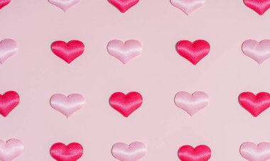 Background pattern pink and red heart on peach colored paper.