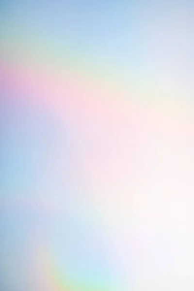 Vertical rainbow hologram background with iridescent colors.