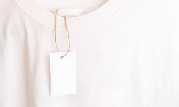 stock image White t-shirt with an empty tag without inscriptions.