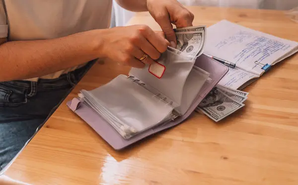Distribution of money among different zip bags in a notepad.
