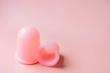 Pembe arka planda anti-selülit masajı için pembe silikon vakum bardakları..
