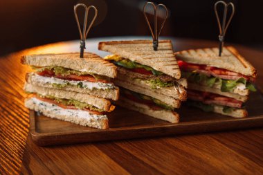 Masada şiş ızgara olan farklı türde üçgen sandviçler..