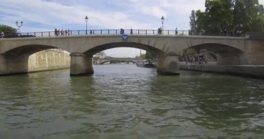Bateau-mouche sailing on the Seine and passing under the Pont de l'Archevch in Paris.