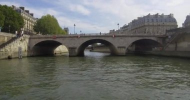 Bateau-mouche sailing on the Seine and passing under the Pont Saint-Michel near Notre Dame of Paris.