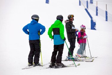 Pas de la Casa, Andorra, December 05 2019: Group of skiers down the ski slope of Grandvalira, the largest ski resort in the Pyrenees and southern Europe.