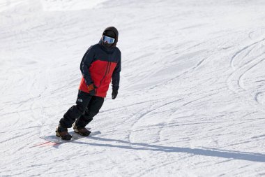 Pas de la Casa, Andorra, December 02 2019: A snowboarder on the ski slope of Grandvalira, the largest ski resort in the Pyrenees and southern Europe.