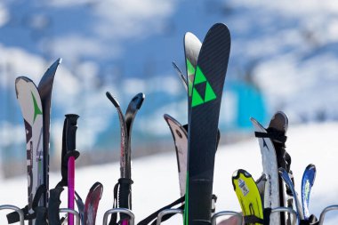 Pas de la Casa, Andorra, December 08 2019: Close-up on a ski rack at the terrace of a caf boarding the ski slope of Grandvalira, the largest ski resort in the Pyrenees and southern Europe. clipart